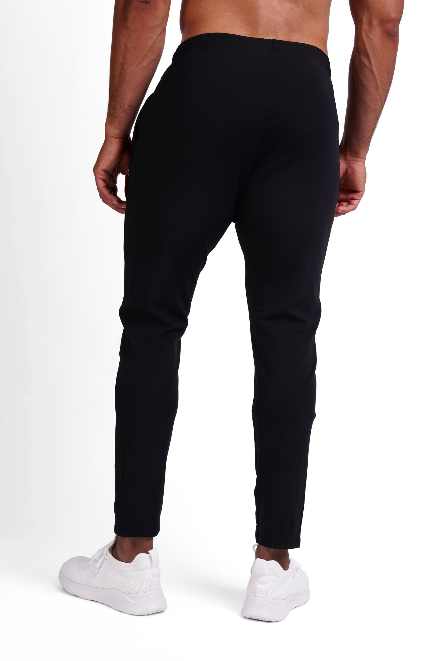 Back view of black OG training pants, clean tapered fit with ankle zip detail