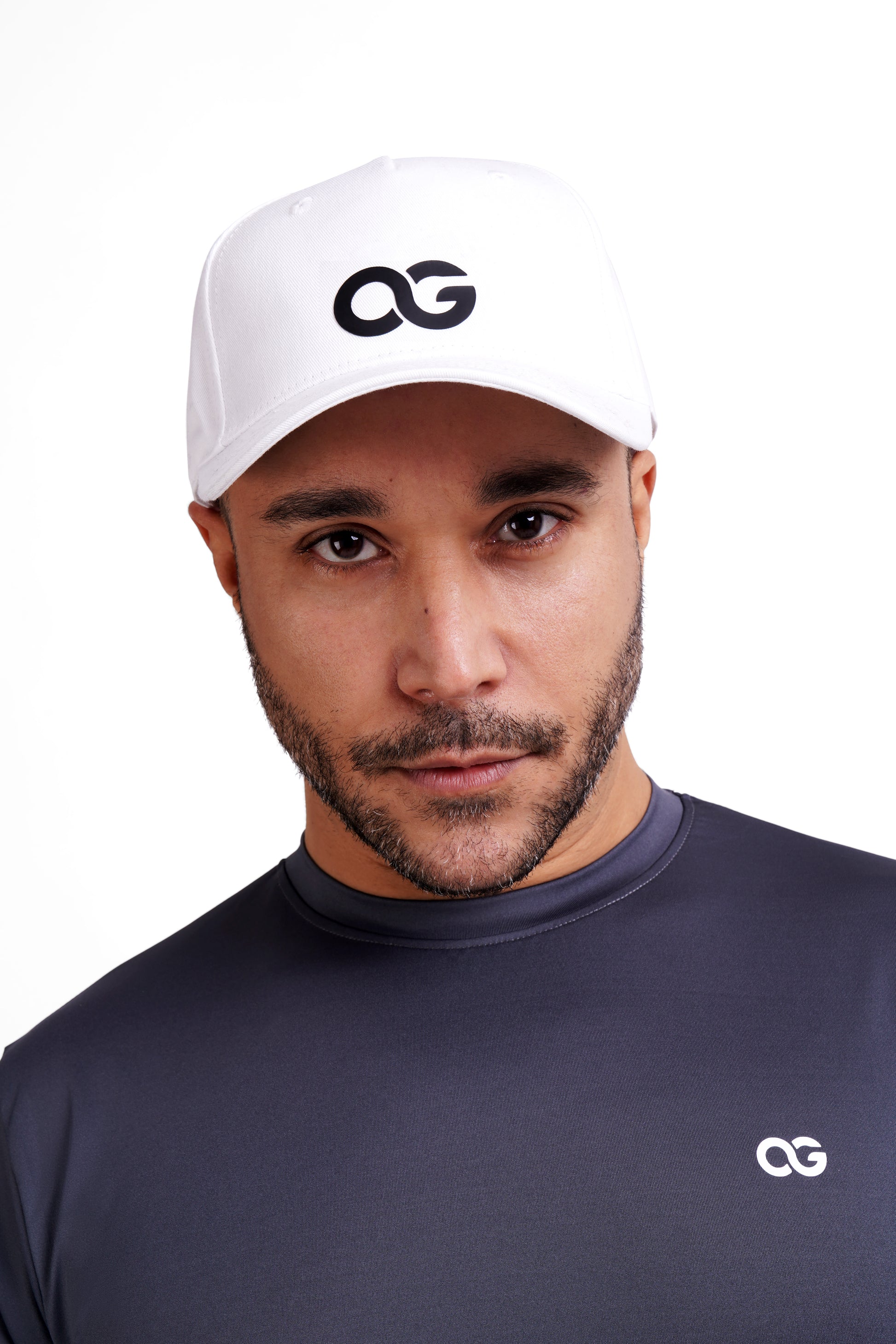 Close-up of a man wearing a white OG cap, confident look, paired with OG training wear