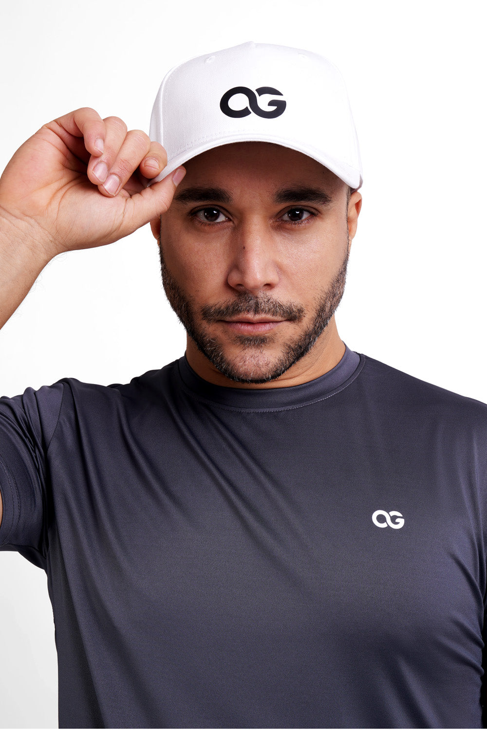 Close-up of a man wearing a white OG cap, confident look, paired with OG training wear