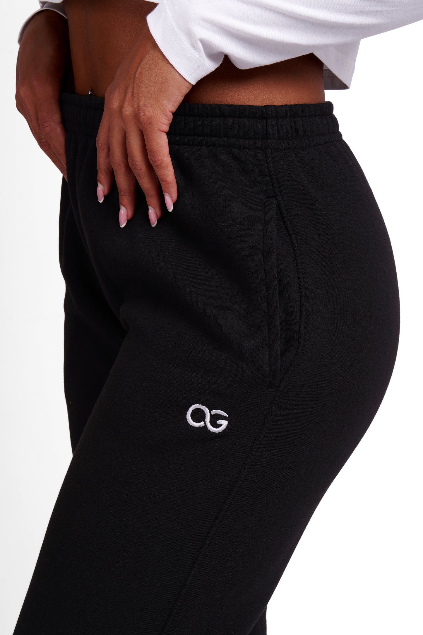 OG Women's Straight Leg Joggers Black - OG logo embroidery close-up, hip detail - Original Greatness