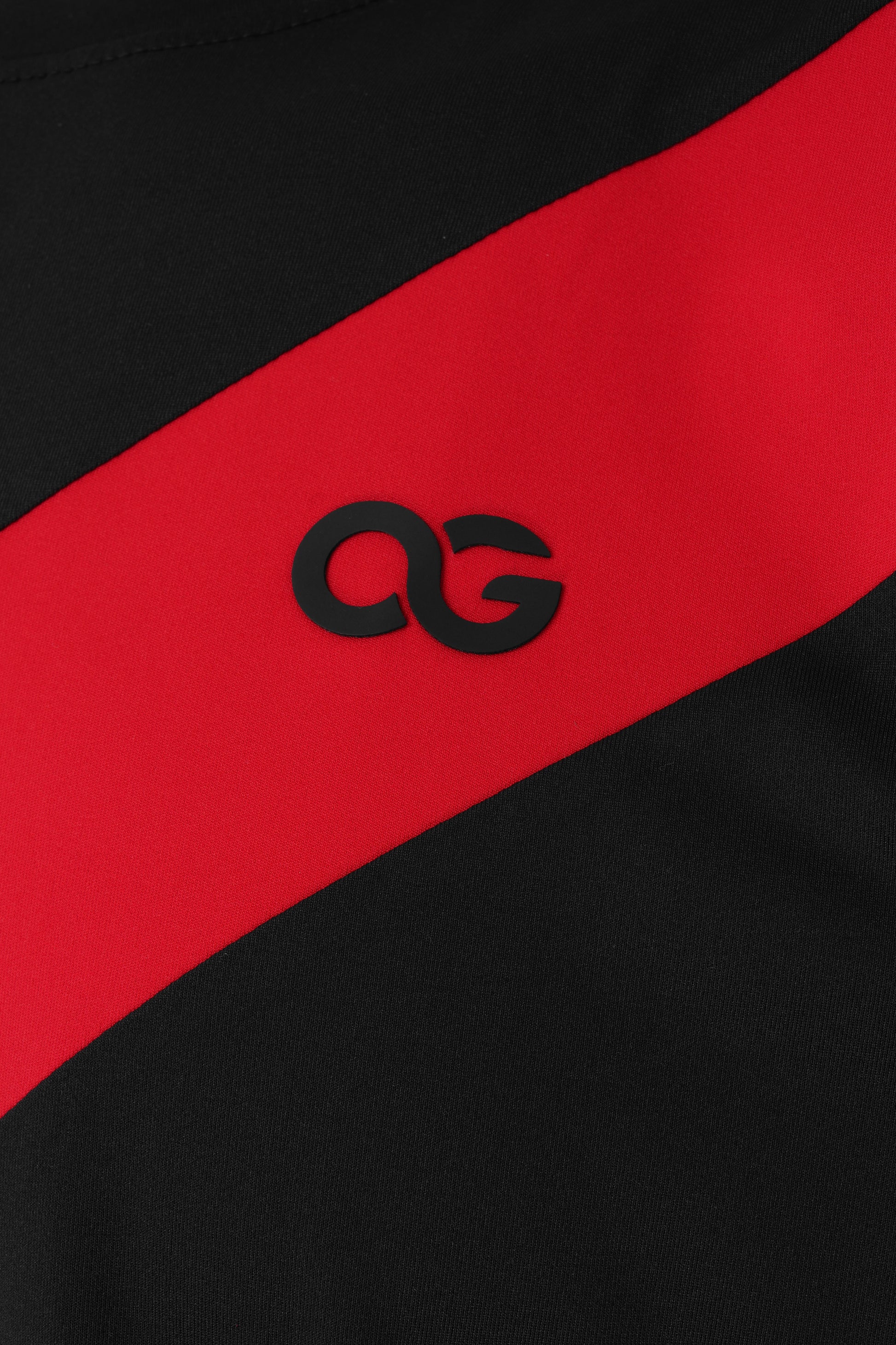 Black and red striped fabric with a logo in the center